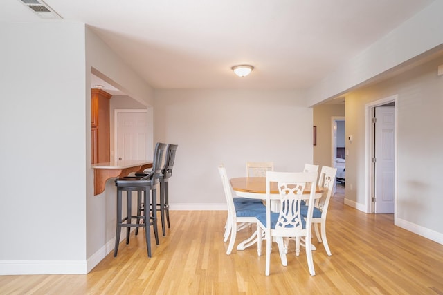 dining area featuring light wood-type flooring