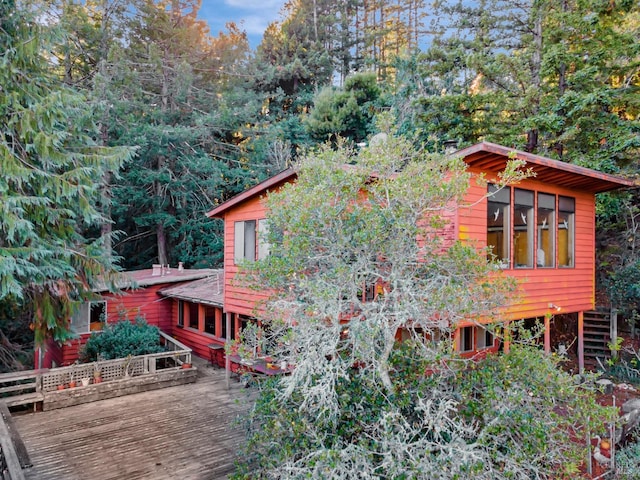 view of property exterior with a deck