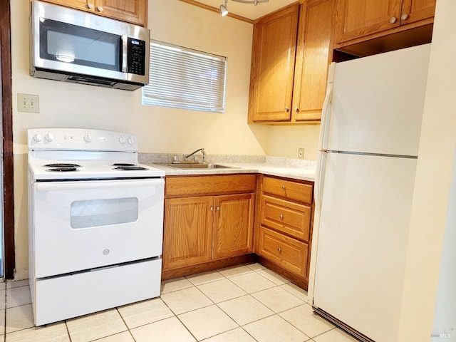 504 Low Gap Rd, Ukiah, CA 95482 - kitchen featuring light countertops, a sink, light tile patterned floors, and white appliances