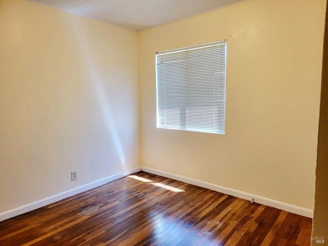 spare room with dark hardwood / wood-style flooring