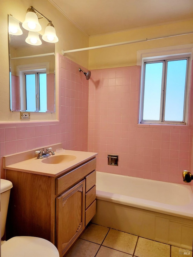 full bathroom with vanity, tile patterned floors, tile walls, and a healthy amount of sunlight