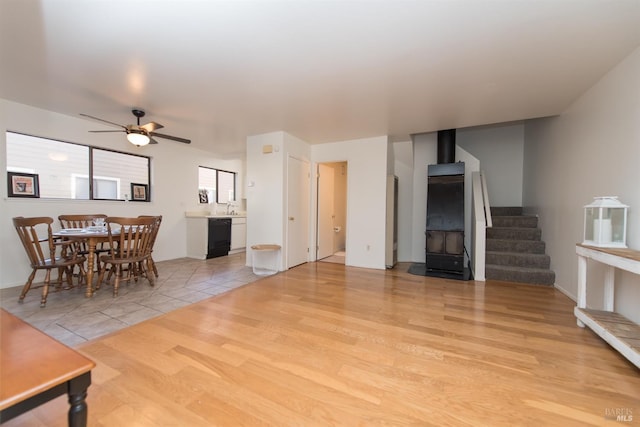 living room with ceiling fan, sink, and light hardwood / wood-style flooring