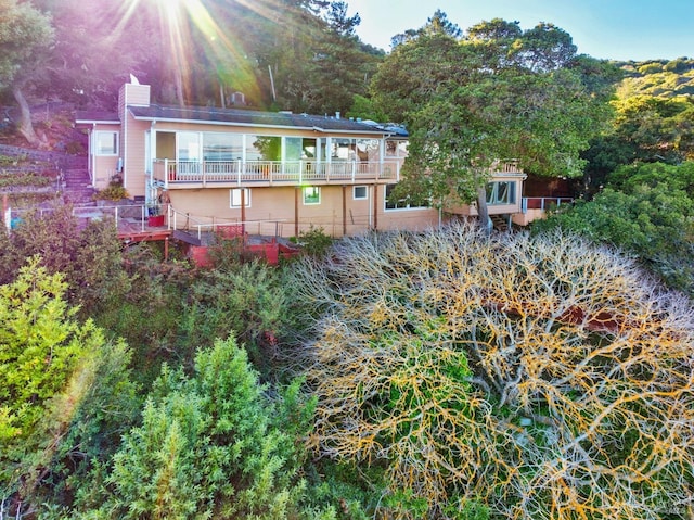 back of property featuring a balcony