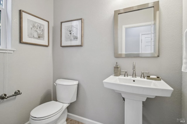 bathroom with tile patterned floors and toilet