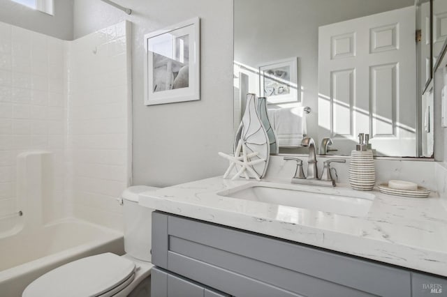 full bathroom with shower / tub combination, vanity, and toilet