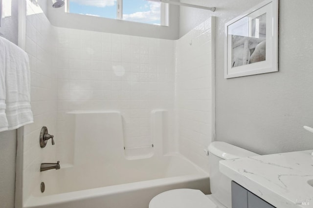 full bathroom featuring toilet, vanity, and tiled shower / bath