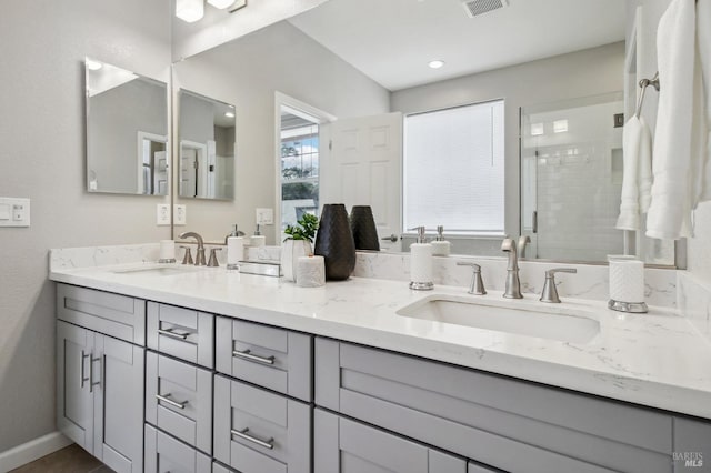 bathroom featuring vanity and an enclosed shower