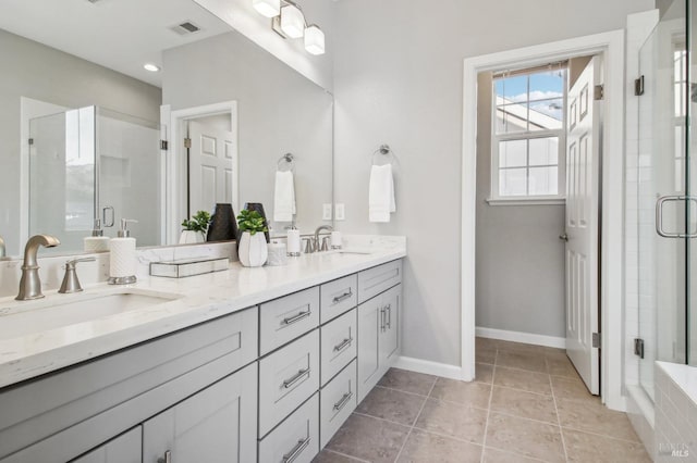 bathroom with vanity, tile patterned floors, and walk in shower