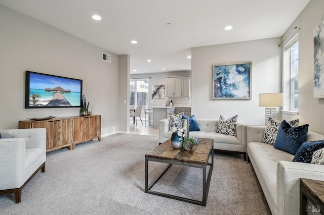 living room with light carpet and a healthy amount of sunlight