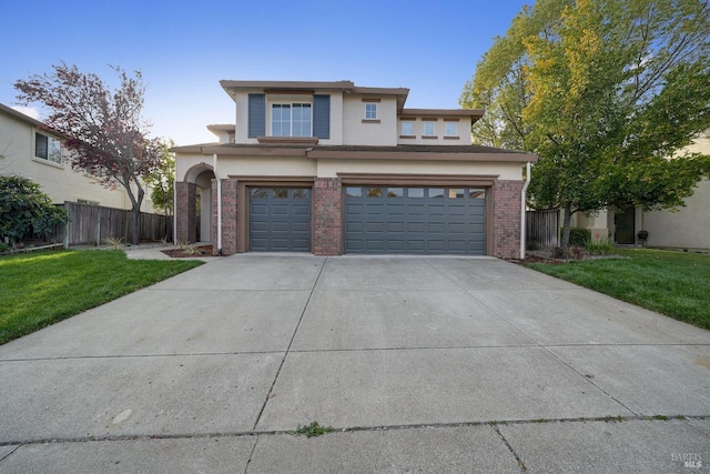 view of front of home featuring driveway, an attached garage, fence, a front lawn, and brick siding