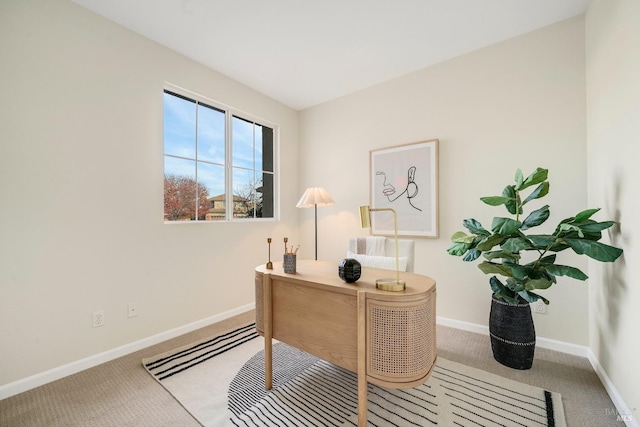 office with light carpet and baseboards