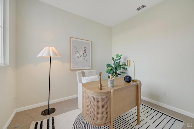 office area with light carpet, baseboards, and visible vents