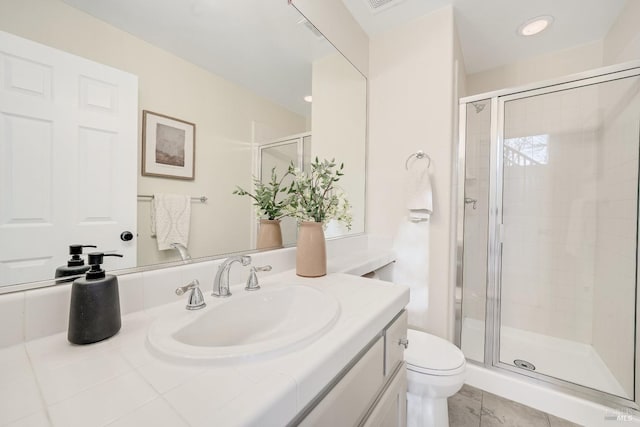 full bath featuring vanity, a shower stall, and toilet