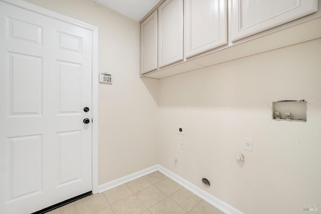 clothes washing area featuring light tile patterned floors, hookup for a washing machine, cabinet space, electric dryer hookup, and baseboards