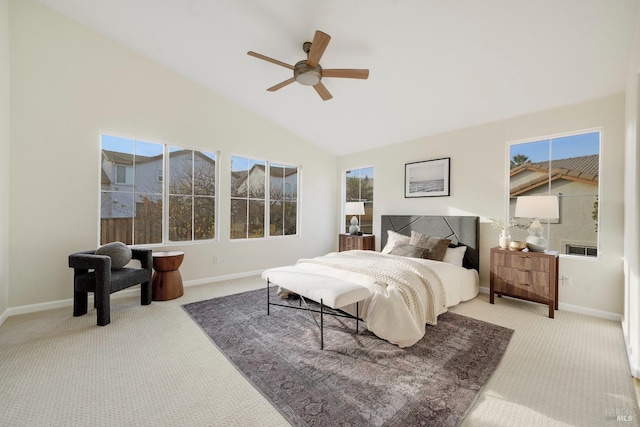 bedroom with baseboards, vaulted ceiling, and light colored carpet