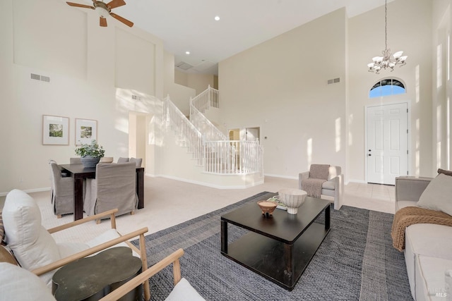 tiled living area with a towering ceiling, stairway, baseboards, and visible vents