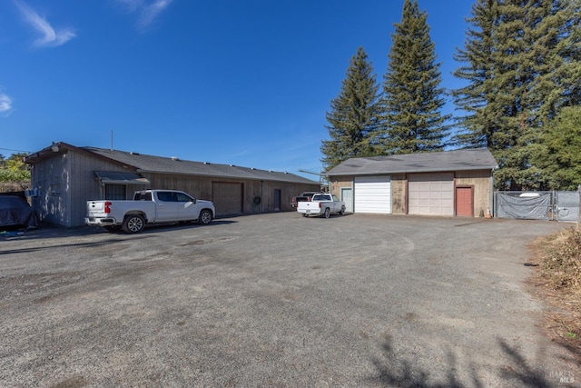 view of front of property featuring a garage and an outdoor structure