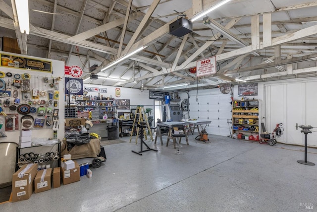 garage featuring a workshop area and a garage door opener