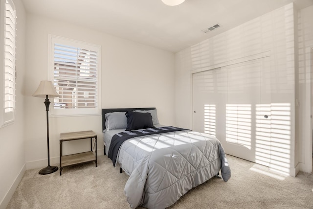 bedroom with visible vents, carpet flooring, and baseboards