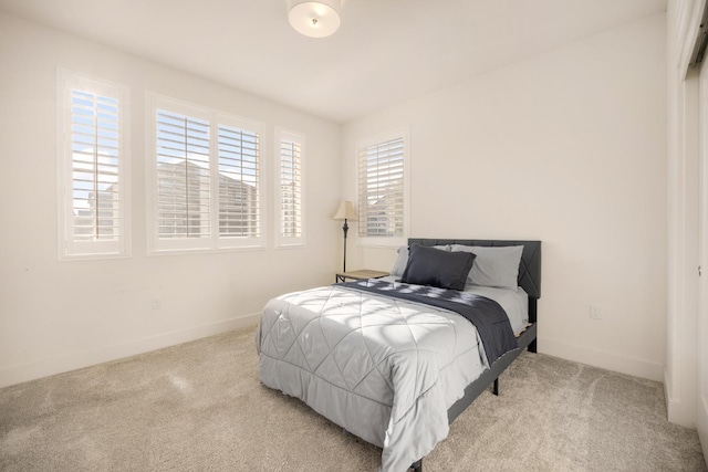 carpeted bedroom with baseboards