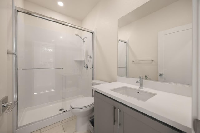 bathroom featuring recessed lighting, tile patterned flooring, toilet, vanity, and a stall shower