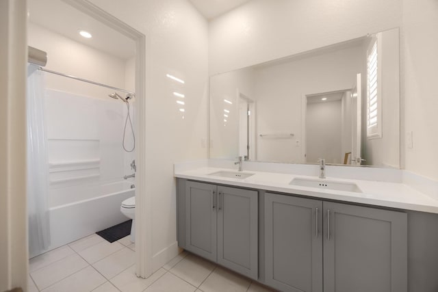 full bath featuring tile patterned floors, a sink, double vanity, and toilet