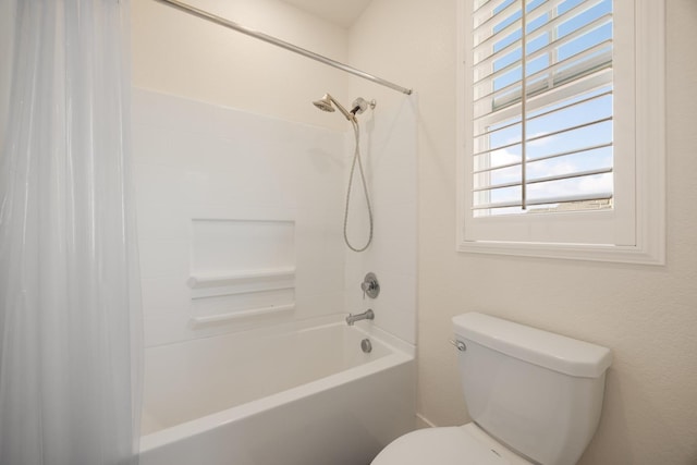 bathroom featuring toilet and shower / bath combination with curtain