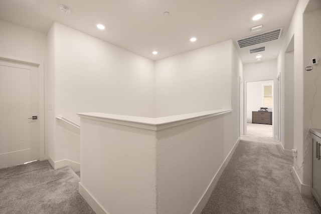 hallway with baseboards, carpet flooring, visible vents, and recessed lighting