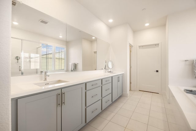 bathroom with tile patterned floors, a sink, a stall shower, double vanity, and visible vents