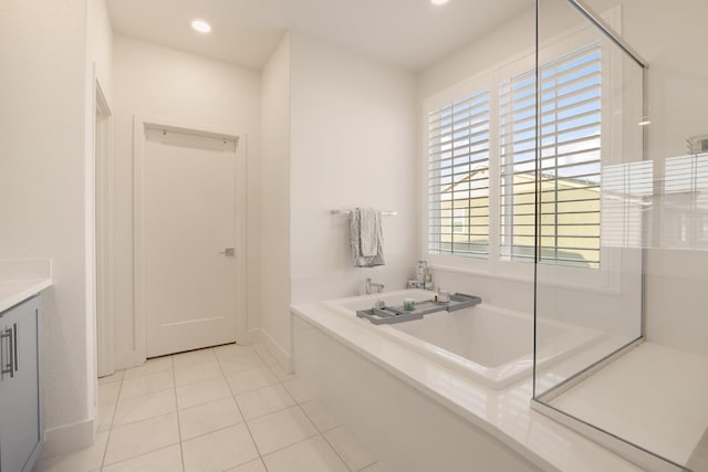 bathroom with recessed lighting, a garden tub, tile patterned floors, and baseboards