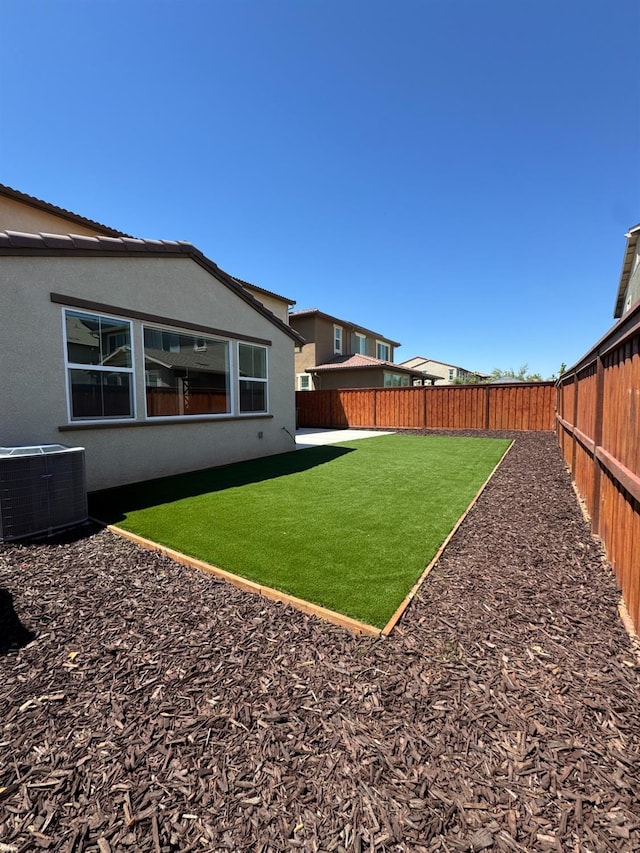 view of yard with a fenced backyard and cooling unit