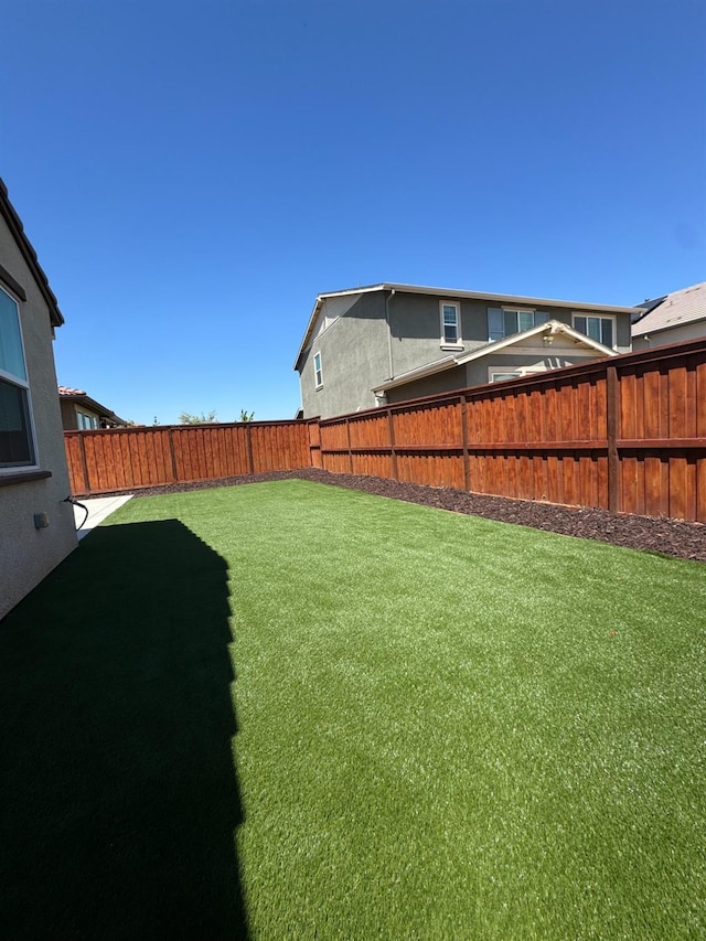view of yard featuring a fenced backyard