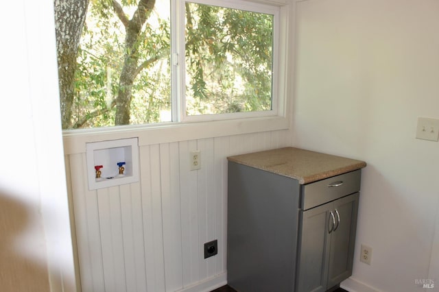 washroom with hookup for an electric dryer, washer hookup, and cabinets