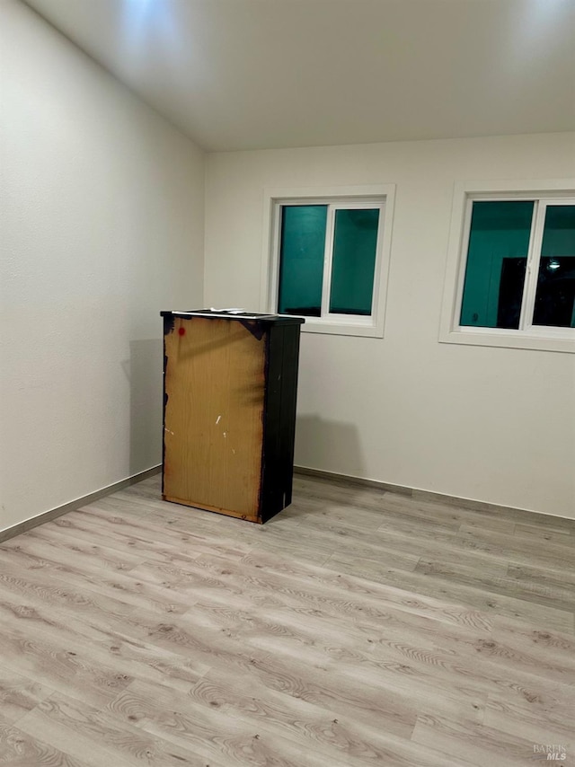 empty room with light hardwood / wood-style floors