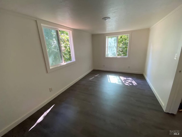 unfurnished room with dark hardwood / wood-style flooring