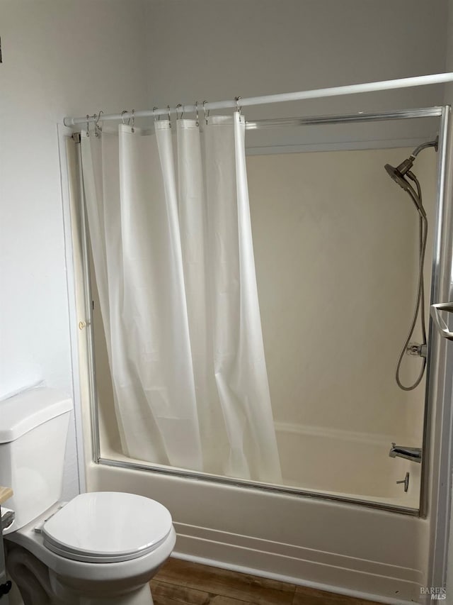 bathroom with toilet, shower / tub combo with curtain, and hardwood / wood-style flooring