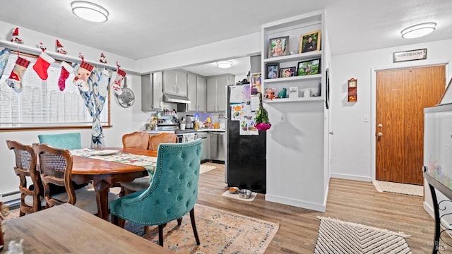 dining space with light hardwood / wood-style flooring