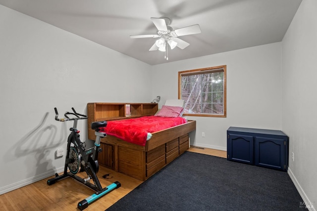 bedroom featuring ceiling fan and dark hardwood / wood-style floors