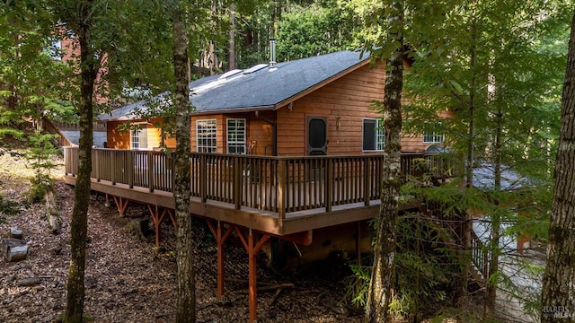 rear view of house featuring a wooden deck