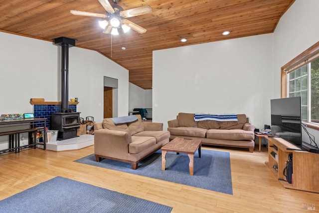 living room with wood ceiling, light hardwood / wood-style flooring, and a wood stove