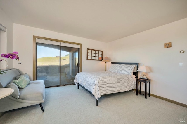 bedroom featuring access to outside and light colored carpet