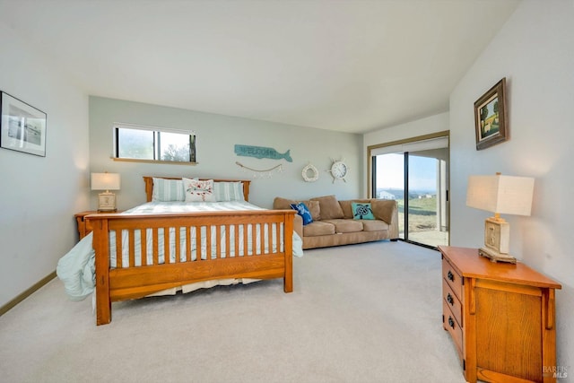 bedroom with access to exterior, light carpet, and multiple windows