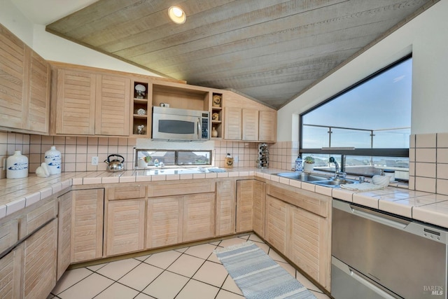 kitchen featuring tile countertops, light brown cabinetry, stainless steel appliances, and sink