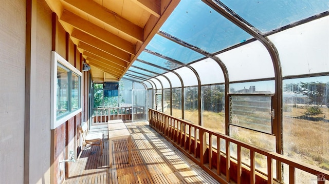 unfurnished sunroom with vaulted ceiling