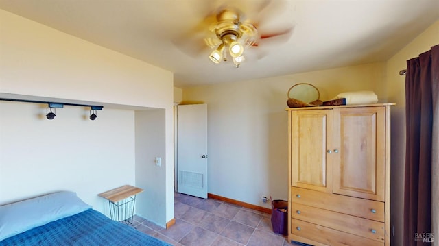 tiled bedroom with ceiling fan