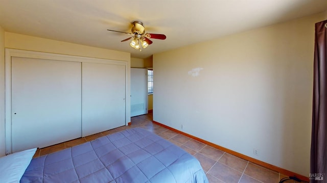 unfurnished bedroom featuring light tile patterned floors, ceiling fan, and a closet