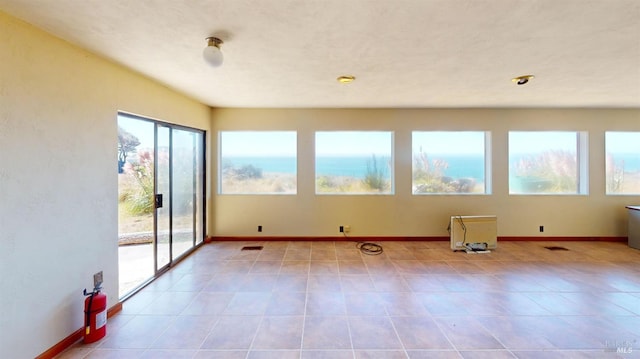 tiled empty room with a water view