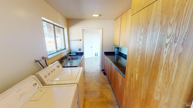 laundry area with cabinets, sink, washing machine and dryer, and light tile patterned floors