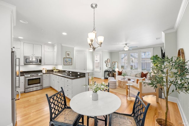 dining space featuring crown molding, ceiling fan with notable chandelier, and light hardwood / wood-style flooring