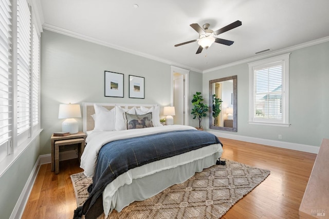 bedroom with ceiling fan, ornamental molding, and light wood-type flooring